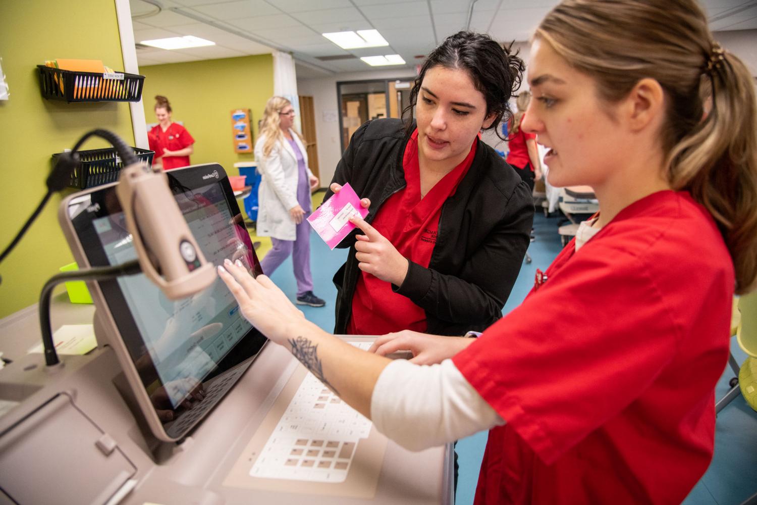 Nursing students utilize the equipment in the Nursing Learning Laboratory.